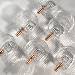 Neptune Glassworks - Bullet Glasses--whiskey glasses with embedded copper bullets, merging bold design with functionality.