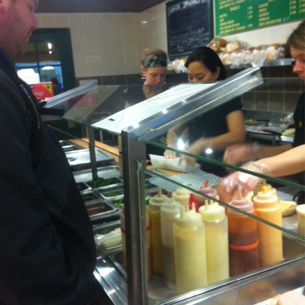 Mama Gratti's Deli & Bakery - a woman serving a sandwich to a man - Bakeries Near Me - Halifax, Nova Scotia Mama Gratti's Deli & Bakery - a woman serving a sandwich to a man - Bakeries Near Me - Halifax, Nova Scotia