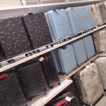Primark - Suitcases - Luggage suitcases featuring Mickey Mouse and other character designs are arranged on store shelves, including black, blue, and marble-patterned options. - Women's Clothing Near Me - Brooklyn, New York
