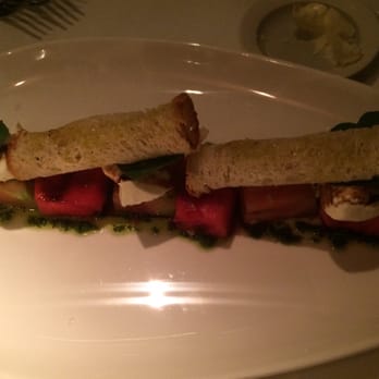 The Dock - Salad with watermelon, mozzarella, tomatoes, and pesto. - New American Near Me - Newport Beach, California The Dock - Salad with watermelon, mozzarella, tomatoes, and pesto. - New American Near Me - Newport Beach, California