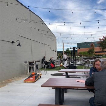 Joe's On Jolly - two men sitting at a picnic table - Bars Near Me - Okemos, Michigan