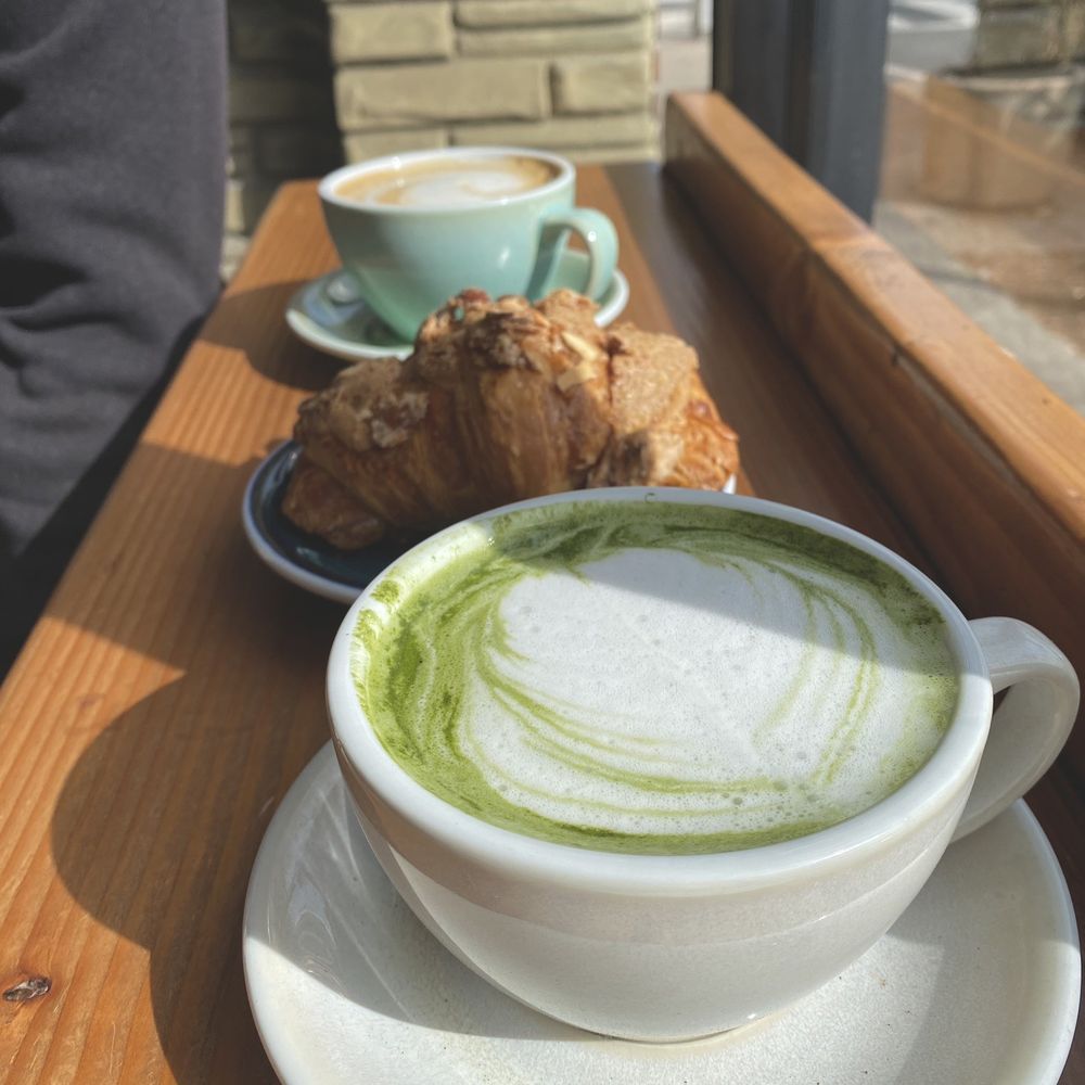 Matcha latte, almond croissant and regular latte