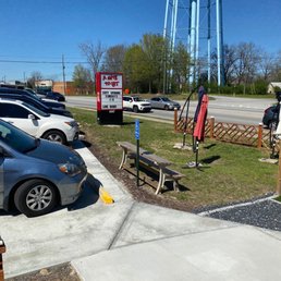 a parking lot with a water tower in the background a parking lot with a water tower in the background