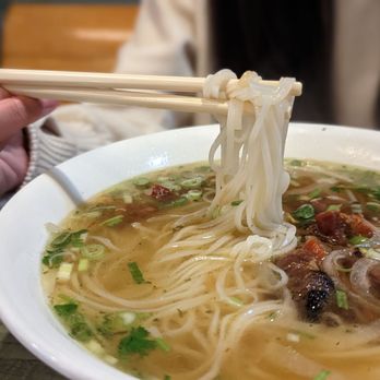 Pho East - a person holding chopsticks over a bowl of soup - Vietnamese Near Me - Toronto, Ontario Pho East - a person holding chopsticks over a bowl of soup - Vietnamese Near Me - Toronto, Ontario