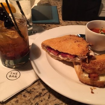 The Bar - a sandwich and a drink on a table - Bars Near Me - Madison, Wisconsin