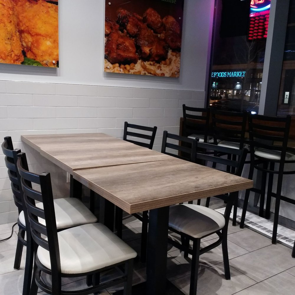 Jerk King - a table and chairs in a restaurant - Caribbean Near Me - Toronto, Ontario Jerk King - a table and chairs in a restaurant - Caribbean Near Me - Toronto, Ontario