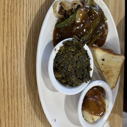 Hamburger steak, turnip greens and mashed potatoes. Hamburger steak, turnip greens and mashed potatoes.