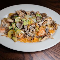 El Agavero - Super A C P; Chicken, steak, shrimp with broccoli, zucchini, squash and mushrooms on a bed of rice with cheese dip over top.