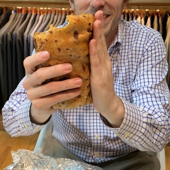 Cabo Bob's Burritos - adult male with hand for sizing of burrito. - Mexican Near Me - Houston, Texas