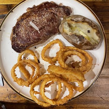The Gin & Granary - Ribeye w/Onion Rings and Baked Potato - Steakhouses Near Me - Wall, Texas The Gin & Granary - Ribeye w/Onion Rings and Baked Potato - Steakhouses Near Me - Wall, Texas