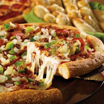 Topper's Pizza - a slice being lifted from a pizza - Pizza Near Me - Val Caron, Ontario Topper's Pizza - a slice being lifted from a pizza - Pizza Near Me - Val Caron, Ontario