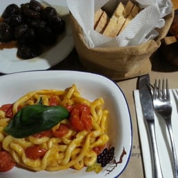 Hand-rolled pasta with cherry tomatoes and basil with side of sweet and sour onions cooked in balsamic vinegar. Hand-rolled pasta with cherry tomatoes and basil with side of sweet and sour onions cooked in balsamic vinegar.