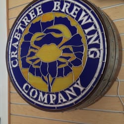 Crabtree Brewing backlit stain glass sign on a barrel made by Bonnie French.