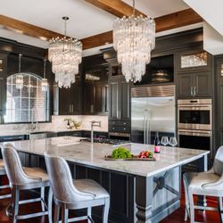 Wiles Design Group - This kitchen features bold cabinets, luxe lighting, and sleek countertops - stylish focal points visible from every part of the house.