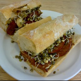 Chorizo, whole roasted garlic and sprouted lentils on a baguette. Chorizo, whole roasted garlic and sprouted lentils on a baguette.