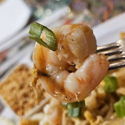 City Corner 2 - A fork holding a shrimp of the Pad Thai Shrimp.