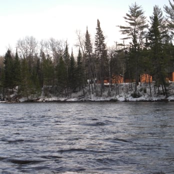 Au Sable Riverview Resort - Riverview Lodge and cabins from the river upstream. - Vacation Rentals Near Me - Grayling, Michigan