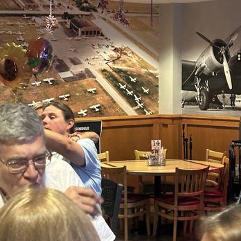 Lynnie Ques BBQ - The restaurant decorated with pictures of the airport. It's at an airport. - Barbeque Near Me - Lansing, Illinois