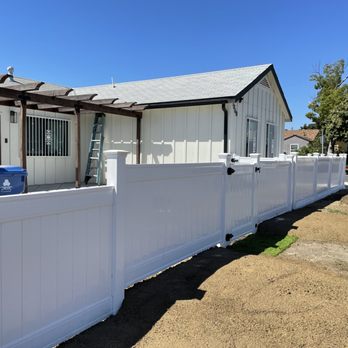 Juca Contractors - a white fence and a house - General Contractors Near Me Juca Contractors - a white fence and a house - General Contractors Near Me