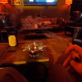 Steampunk Cigar - a man sitting in a living room watching tv - Cigar Bars Near Me - Sacramento, California Steampunk Cigar - a man sitting in a living room watching tv - Cigar Bars Near Me - Sacramento, California