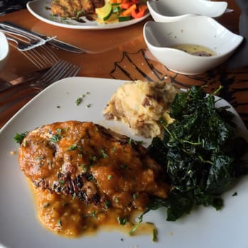 Islands Fish Grill - Cobia special with fried spinach and garlic mashed potatoes. In background: Mahi special with sautéed veggies. - Seafood Near Me - Indialantic, Florida