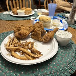 Two chicken dinners. Some fries were already eaten. The cole slaw is in the white container. Look at the BUN! Two chicken dinners. Some fries were already eaten. The cole slaw is in the white container. Look at the BUN!