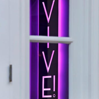Vive! - a purple neon sign in a window - Lounges Near Me - New Orleans, Louisiana Vive! - a purple neon sign in a window - Lounges Near Me - New Orleans, Louisiana