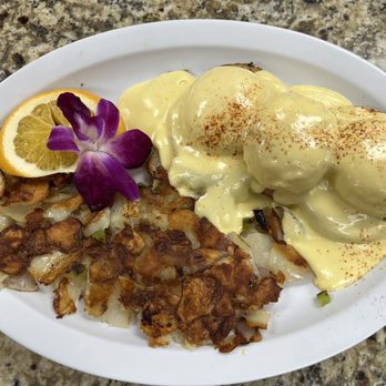 Breakfast Shack - Eggs Benedict with home potatoes. The garnish is an orange an edible flower (I asked) it taste like a flower lol - Breakfast & Brunch Near Me - Redlands, California