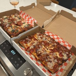 The classic cheese "Formaggi" pizza and "The Millie" pepperoni pizza.