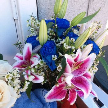 Maggie's Flowers - My bridal bouquet (blue roses & starfire lilies ) with a glimpse of the all-white bouquet for the Virgin Mary - Florists Near Me - San Fernando, California Maggie's Flowers - My bridal bouquet (blue roses & starfire lilies ) with a glimpse of the all-white bouquet for the Virgin Mary - Florists Near Me - San Fernando, California