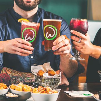Wahlburgers @ Hy-Vee - two people holding glasses of beer - Salad Near Me - Manhattan, Kansas Wahlburgers @ Hy-Vee - two people holding glasses of beer - Salad Near Me - Manhattan, Kansas