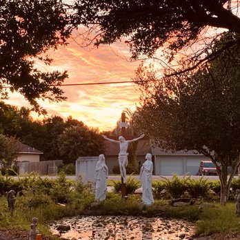 Corpus Christi Catholic Church - The cross in front of the pond in the church garden - Churches Near Me - Destin, Florida Corpus Christi Catholic Church - The cross in front of the pond in the church garden - Churches Near Me - Destin, Florida