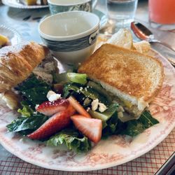 A light lunch of strawberry fields salad, a toasted egg salad sandwich and chicken salad on a croissant