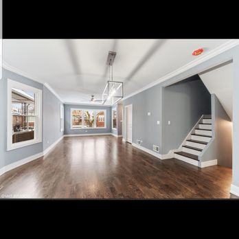 Remodify - an empty living room with hardwood floors - Painters Near Me Remodify - an empty living room with hardwood floors - Painters Near Me