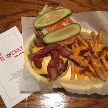 Red Rocket Bar & Grill - All American Burger-
8oz steak burger topped with bacon, lettuce, tomato and onion.
Served with Fries - Bars Near Me - Peru, Indiana Red Rocket Bar & Grill - All American Burger-
8oz steak burger topped with bacon, lettuce, tomato and onion.
Served with Fries - Bars Near Me - Peru, Indiana