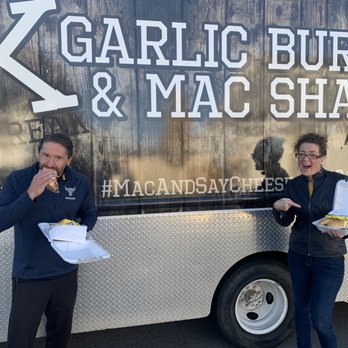 BK Garlic Burger & Mac Shack - two people standing in front of a food truck - Food Trucks Near Me BK Garlic Burger & Mac Shack - two people standing in front of a food truck - Food Trucks Near Me