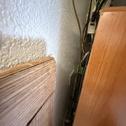 Town House Motel - A jumble of cords and lint/ hair, mini fridge not sufficiently plugged in. And then there's the debris/ garbage in all those cords.