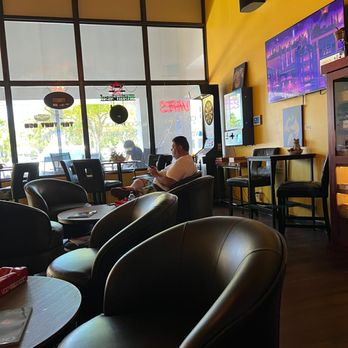 Tap That Ash - a man sitting in a restaurant - Cigar Bars Near Me - Wilton Manors, Florida Tap That Ash - a man sitting in a restaurant - Cigar Bars Near Me - Wilton Manors, Florida