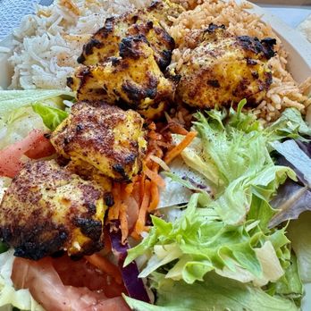 Reston Kabob - Same!!! - A plate of grilled chicken pieces served with rice, fresh salad, and vegetables, likely from a Middle Eastern or Mediterranean restaurant. - Afghan Near Me - Reston, Virginia