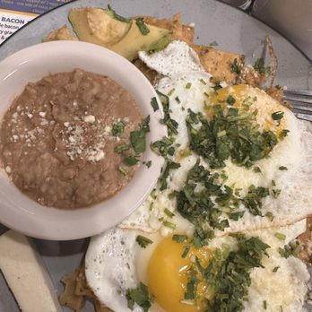 Time to Rise and Shine - Chilaquiles verdes with side of beans and cheso fresco - Breakfast & Brunch Near Me - Omaha, Nebraska Time to Rise and Shine - Chilaquiles verdes with side of beans and cheso fresco - Breakfast & Brunch Near Me - Omaha, Nebraska