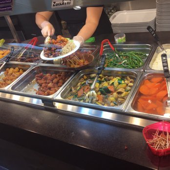 Bourbon Street Grill - a person serving a variety of food - Cajun/Creole Near Me - Calgary, Alberta