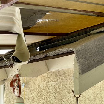 Mcs Awnings - Torn awning from fallen roof tile, seen from below. - Awnings Near Me - Hayward, California