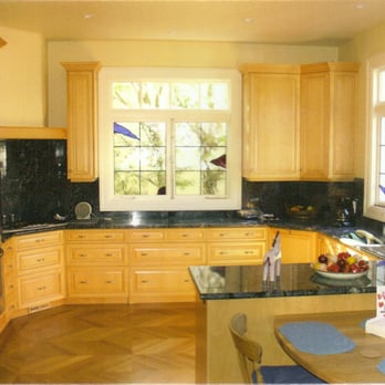 Safety Construction - a kitchen with wooden cabinets and black counter tops - General Contractors Near Me - Oakland, California Safety Construction - a kitchen with wooden cabinets and black counter tops - General Contractors Near Me - Oakland, California