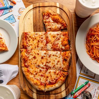 Penne Pomodoro - Cheese pizza and a plate of spaghetti served on a table at Penne Pomodoro. - Italian Near Me - Dallas, Texas Penne Pomodoro - Cheese pizza and a plate of spaghetti served on a table at Penne Pomodoro. - Italian Near Me - Dallas, Texas