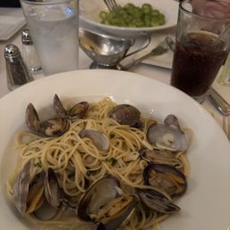 Spaghetti vongole and my son's gnocci with pesto in background Spaghetti vongole and my son's gnocci with pesto in background