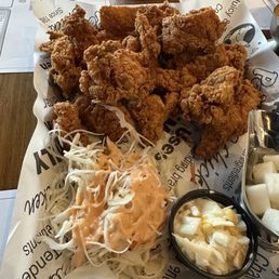 Whole boneless crispy chicken with sauce on side. Whole boneless crispy chicken with sauce on side.