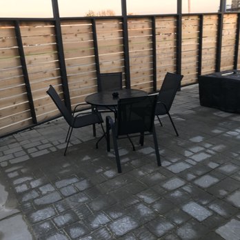 The Rabbit's Foot - a patio with a table and chairs - American Near Me - Rochelle, Illinois The Rabbit's Foot - a patio with a table and chairs - American Near Me - Rochelle, Illinois