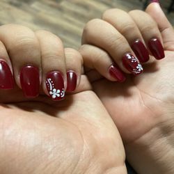 Oasis Nail and Spa - Short dark red nails with flower design