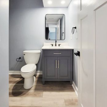 MAK Remodeling Services - a bathroom with a toilet, sink, and mirror - General Contractors Near Me - Fort Washington, Maryland