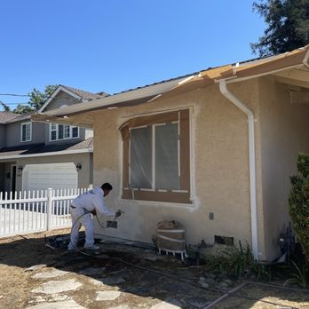 Creation Painting - spray paint wall (covered windows & trim, nearby pipes, and gutters) - Painters Near Me